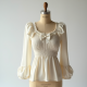 Ruffled Smocked Blouse with Bow Detail